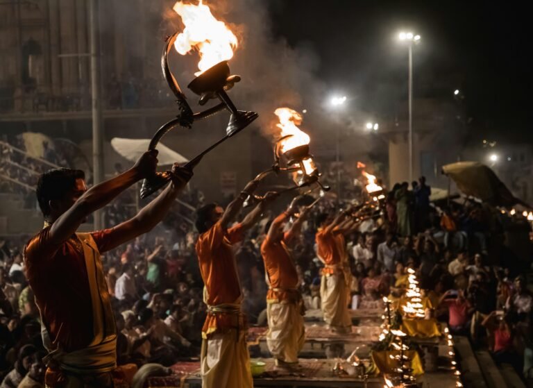 Evening Ganga Aarti ceremony at Dasaswamedh Ghat with priests holding flaming torches.